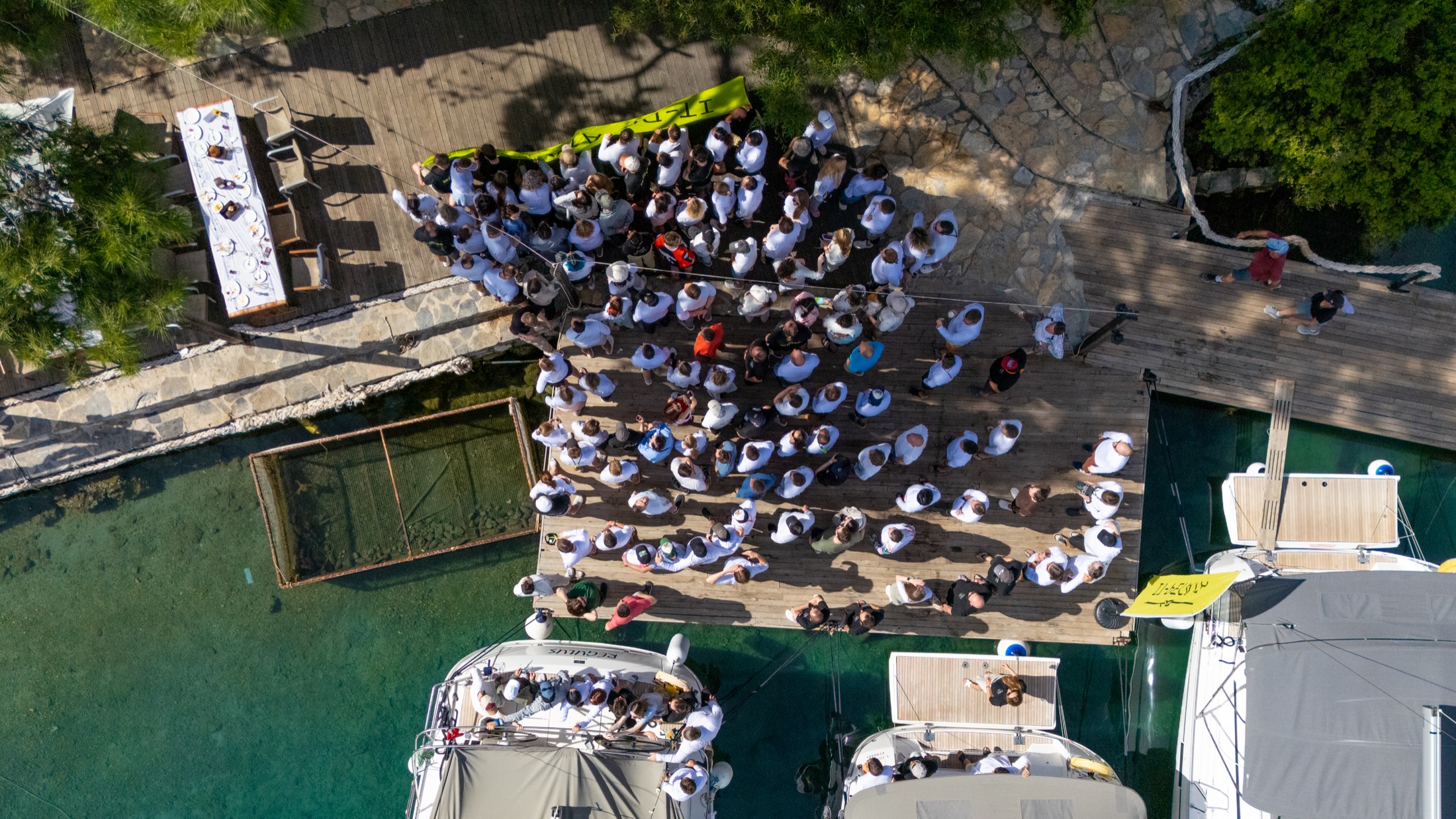 Sailors gathered at a marina before a water session